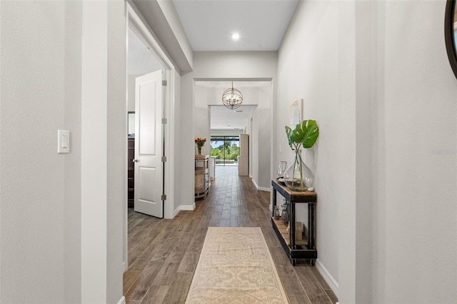 15316 Shady Palms Ln, Nokomis, FL 34275 - hallway with wood finished floors, a chandelier, and recessed lighting