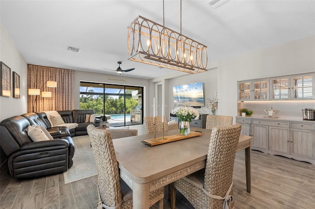 15316 Shady Palms Ln, Nokomis, FL 34275 - dining room featuring a ceiling fan and light wood finished floors
