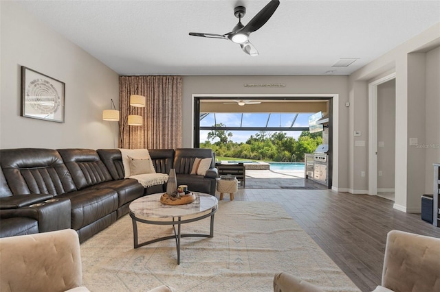 15316 Shady Palms Ln, Nokomis, FL 34275 - living area featuring a sunroom, ceiling fan, and wood finished floors