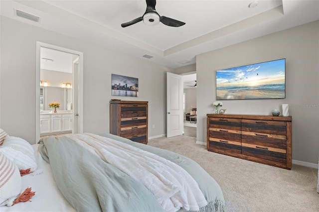 15316 Shady Palms Ln, Nokomis, FL 34275 - carpeted bedroom with ensuite bath, ceiling fan, and a raised ceiling
