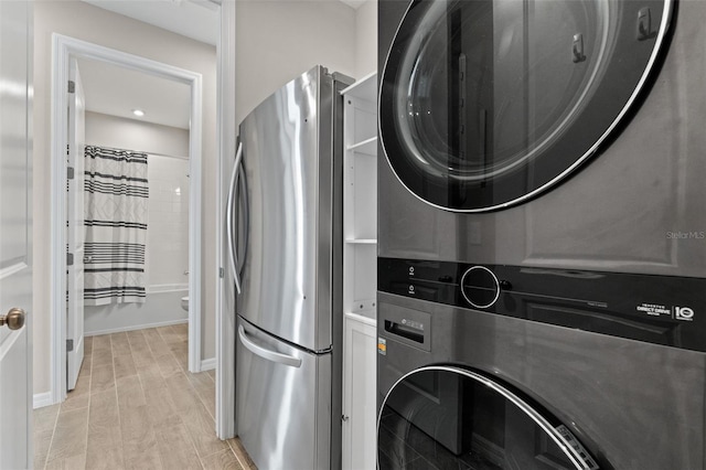 15316 Shady Palms Ln, Nokomis, FL 34275 - laundry room featuring stacked washer / drying machine and baseboards