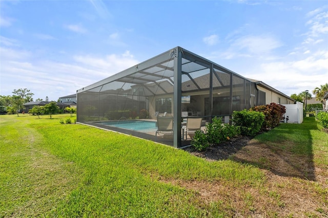 15316 Shady Palms Ln, Nokomis, FL 34275 - back of house with a lawn, an outdoor pool, a patio area, and glass enclosure