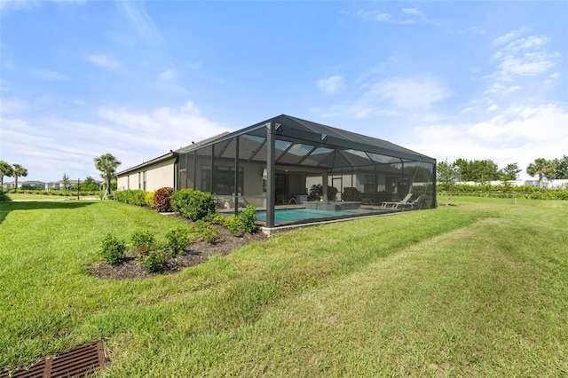 15316 Shady Palms Ln, Nokomis, FL 34275 - rear view of house with a yard, an outdoor pool, and glass enclosure