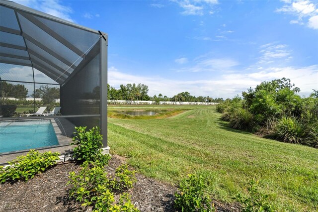 15316 Shady Palms Ln, Nokomis, FL 34275 - view of grassy yard featuring a water view, glass enclosure, and an outdoor pool