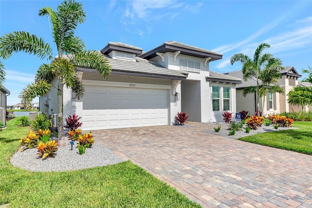 17333 Savory Mist Cir, Bradenton, FL 34211 - view of front of house with stucco siding, a tiled roof, a garage, driveway, and a front lawn