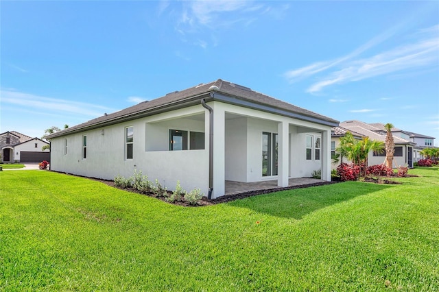 17333 Savory Mist Cir, Bradenton, FL 34211 - view of property exterior featuring stucco siding, a lawn, and a patio