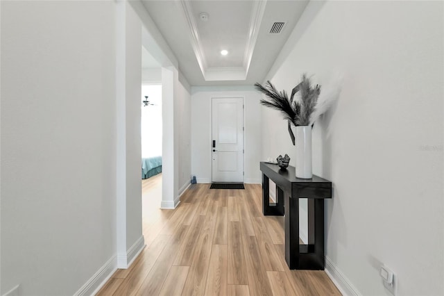 17333 Savory Mist Cir, Bradenton, FL 34211 - hall featuring light wood-style flooring, a tray ceiling, baseboards, ornamental molding, and recessed lighting