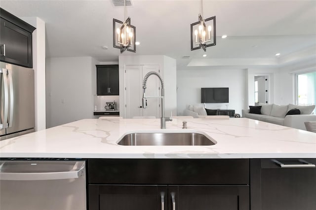 17333 Savory Mist Cir, Bradenton, FL 34211 - kitchen featuring stainless steel appliances, a chandelier, open floor plan, a sink, and hanging light fixtures
