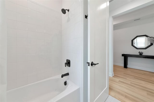 17333 Savory Mist Cir, Bradenton, FL 34211 - full bathroom featuring shower / bath combination, wood finished floors, and baseboards