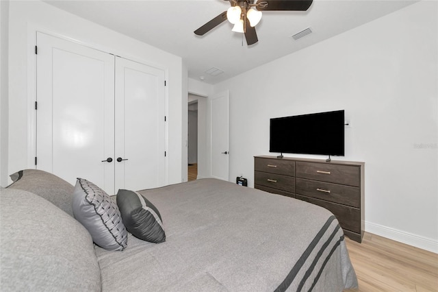 17333 Savory Mist Cir, Bradenton, FL 34211 - bedroom featuring light wood-type flooring, baseboards, ceiling fan, and a closet