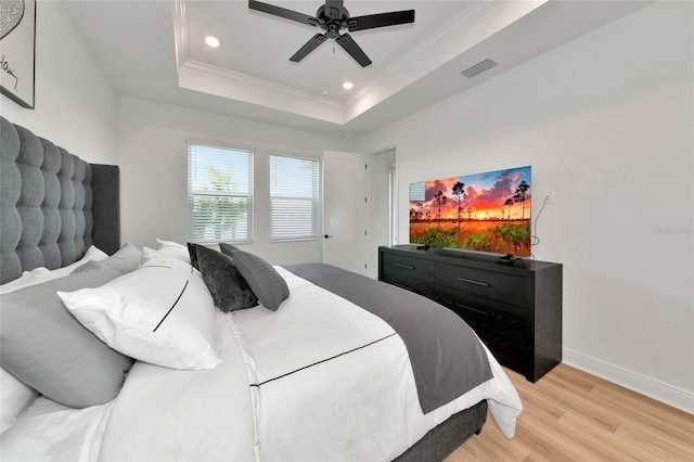 17333 Savory Mist Cir, Bradenton, FL 34211 - bedroom featuring light wood-type flooring, ornamental molding, baseboards, recessed lighting, and a tray ceiling