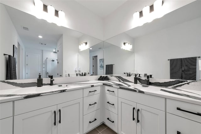 17333 Savory Mist Cir, Bradenton, FL 34211 - bathroom with a shower stall, double vanity, and tile patterned flooring