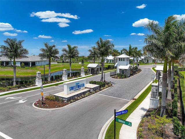 17333 Savory Mist Cir, Bradenton, FL 34211 - view of asphalt road featuring curbs, sidewalks, a water view, a residential view, and traffic signs