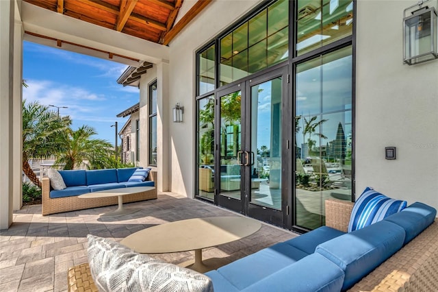 17333 Savory Mist Cir, Bradenton, FL 34211 - doorway featuring wooden ceiling with exposed beams, stone tile flooring, and a towering ceiling