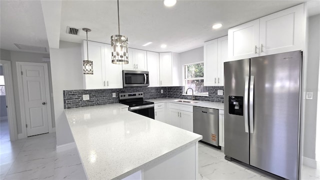 6404 8th Street Ct W, Bradenton, FL 34207 - kitchen with stainless steel appliances, light marble finish flooring, a peninsula, a sink, and recessed lighting