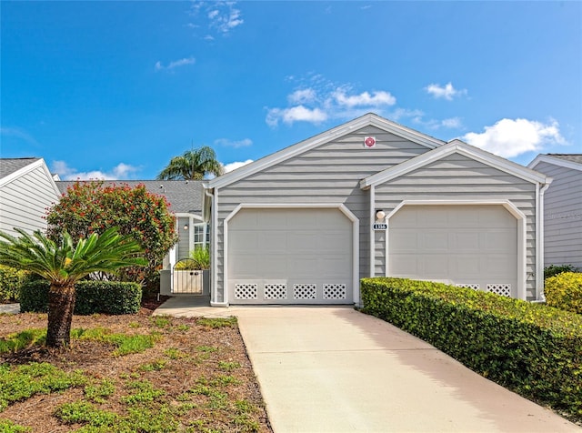 1316 Perico Point Cir, Bradenton, FL 34209 - view of front of house featuring driveway, an attached garage, and a gate
