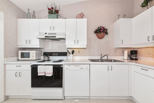 1316 Perico Point Cir, Bradenton, FL 34209 - kitchen with white appliances, under cabinet range hood, wallpapered walls, white cabinets, and light countertops