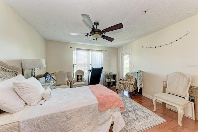 4057 Crockers Lake Blvd Unit 15, Sarasota, FL 34238 - bedroom featuring wood finished floors, a textured ceiling, and ceiling fan