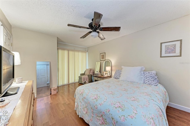 4057 Crockers Lake Blvd Unit 15, Sarasota, FL 34238 - bedroom featuring light wood-style floors, a ceiling fan, and a textured ceiling