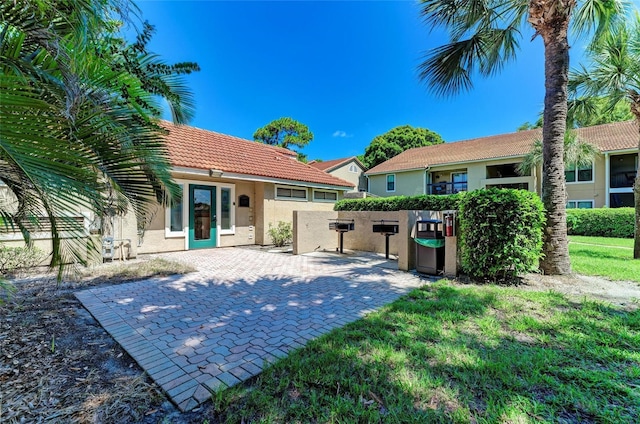4057 Crockers Lake Blvd Unit 15, Sarasota, FL 34238 - rear view of house with stucco siding, a tile roof, and a patio