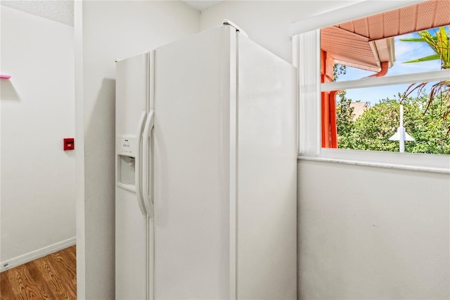 5500 Longwood Run Blvd Unit 203, Sarasota, FL 34243 - kitchen featuring white fridge with ice dispenser and wood finished floors
