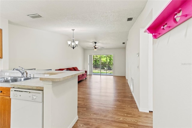 5500 Longwood Run Blvd Unit 203, Sarasota, FL 34243 - kitchen featuring dishwasher, light wood-style flooring, open floor plan, light countertops, and a textured ceiling