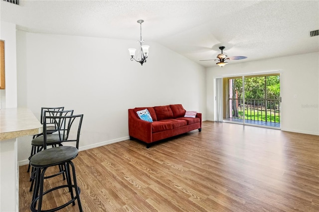 5500 Longwood Run Blvd Unit 203, Sarasota, FL 34243 - living room with wood finished floors, a ceiling fan, a chandelier, a textured ceiling, and lofted ceiling