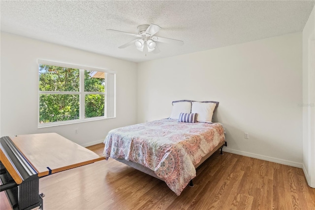 5500 Longwood Run Blvd Unit 203, Sarasota, FL 34243 - bedroom featuring wood finished floors, a textured ceiling, and ceiling fan