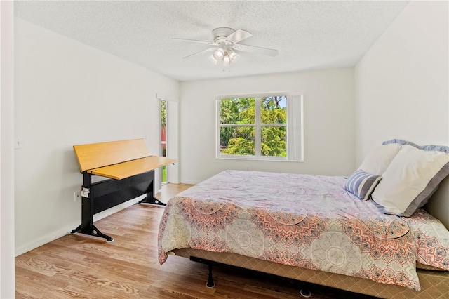5500 Longwood Run Blvd Unit 203, Sarasota, FL 34243 - bedroom featuring wood finished floors, a textured ceiling, and a ceiling fan