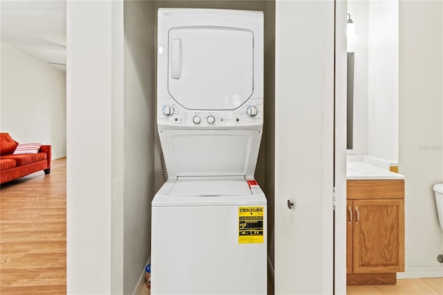 5500 Longwood Run Blvd Unit 203, Sarasota, FL 34243 - laundry room featuring stacked washer / drying machine and light wood-style flooring