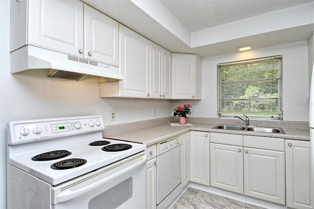 1354 22nd St, Sarasota, FL 34234 - kitchen featuring white appliances, under cabinet range hood, white cabinetry, light marble finish floors, and light countertops