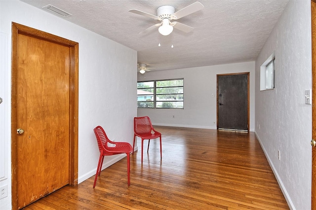 1354 22nd St, Sarasota, FL 34234 - living area featuring hardwood / wood-style flooring, ceiling fan, a textured ceiling, and a textured wall