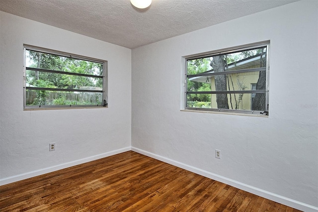 1354 22nd St, Sarasota, FL 34234 - empty room with plenty of natural light, wood finished floors, and a textured ceiling