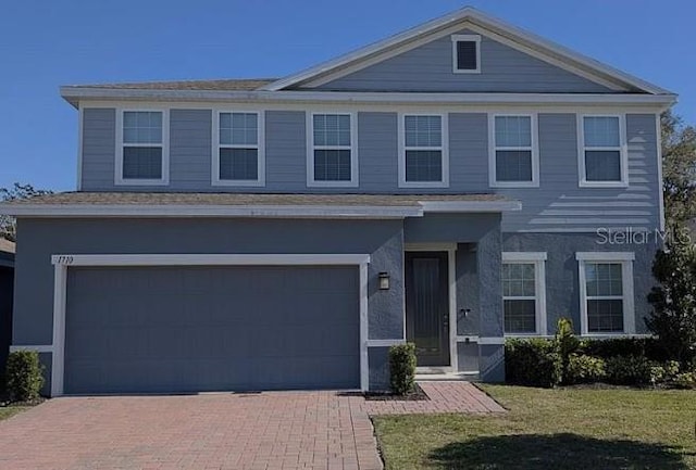 1710 Summer Rose Dr, Mount Dora, FL 32757 - traditional-style house with a garage, decorative driveway, and a front lawn