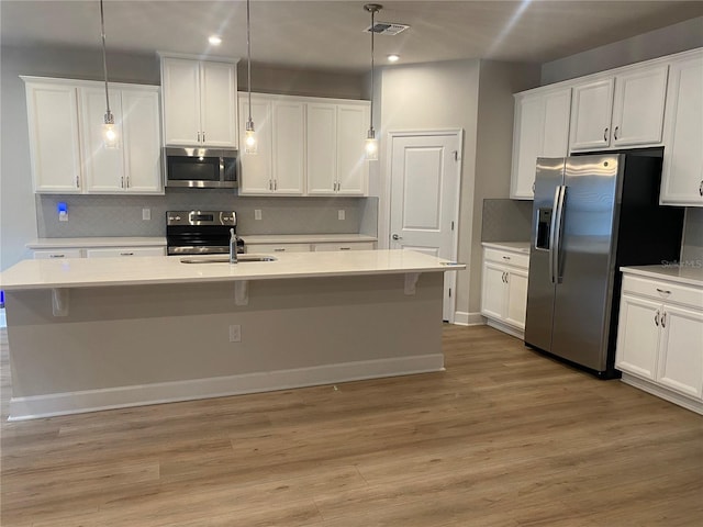 1710 Summer Rose Dr, Mount Dora, FL 32757 - kitchen featuring appliances with stainless steel finishes, light wood-style floors, white cabinets, and recessed lighting