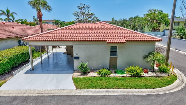 139 Vista Hermosa Cir, Sarasota, FL 34242 - view of front of house featuring a tile roof, stucco siding, driveway, and an attached carport