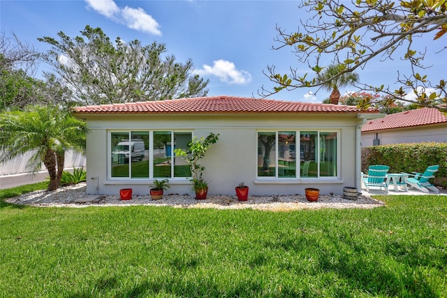 139 Vista Hermosa Cir, Sarasota, FL 34242 - back of house featuring stucco siding, a lawn, a tile roof, and a patio area