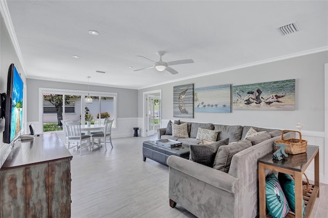 139 Vista Hermosa Cir, Sarasota, FL 34242 - living room with wainscoting, ornamental molding, ceiling fan, light wood-type flooring, and recessed lighting