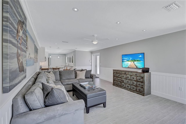 139 Vista Hermosa Cir, Sarasota, FL 34242 - living room featuring wainscoting, light wood-type flooring, a ceiling fan, recessed lighting, and a decorative wall