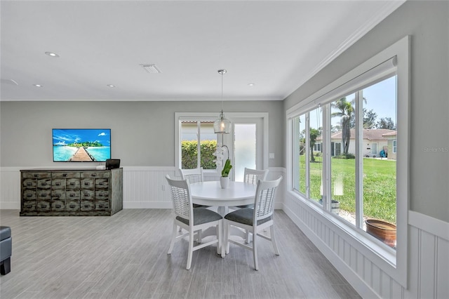 139 Vista Hermosa Cir, Sarasota, FL 34242 - dining space with wainscoting, wood finished floors, a decorative wall, ornamental molding, and recessed lighting