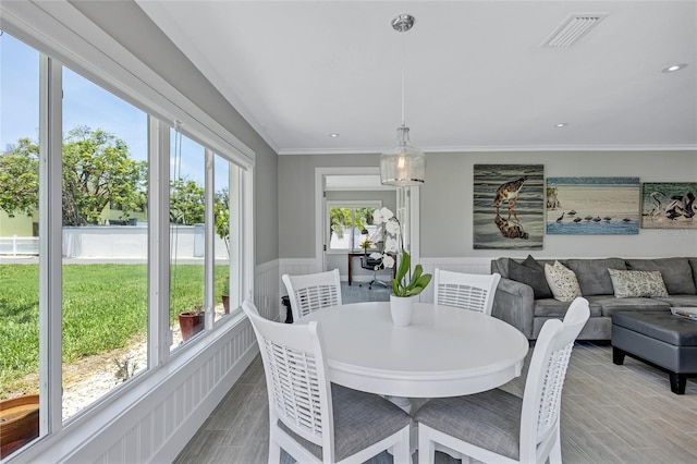 139 Vista Hermosa Cir, Sarasota, FL 34242 - dining area with wainscoting, recessed lighting, ornamental molding, and light wood-style floors