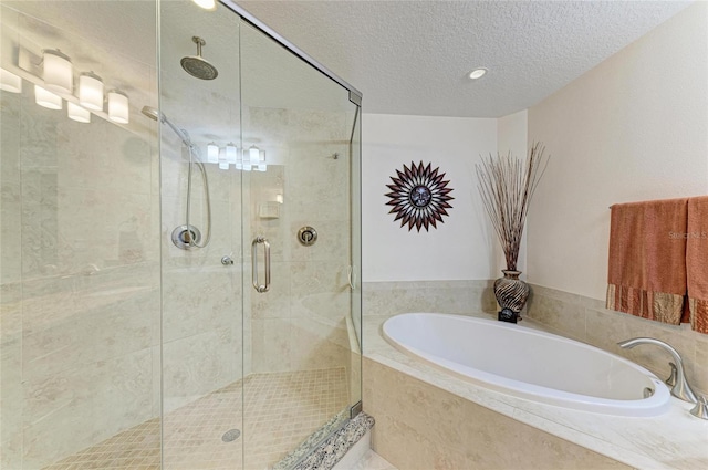 7820 34th Ave W Unit 102, Bradenton, FL 34209 - bathroom with a garden tub, a stall shower, and a textured ceiling