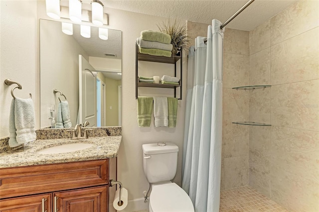 7820 34th Ave W Unit 102, Bradenton, FL 34209 - full bathroom featuring vanity, a tile shower, and a textured ceiling