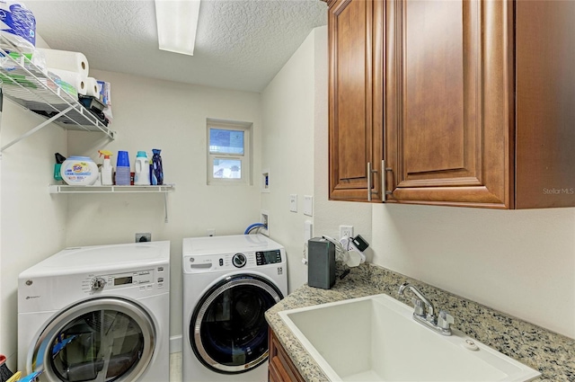 7820 34th Ave W Unit 102, Bradenton, FL 34209 - laundry room featuring separate washer and dryer, cabinet space, and a textured ceiling