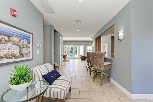 7820 34th Ave W Unit 102, Bradenton, FL 34209 - hallway featuring recessed lighting, light tile patterned floors, and french doors