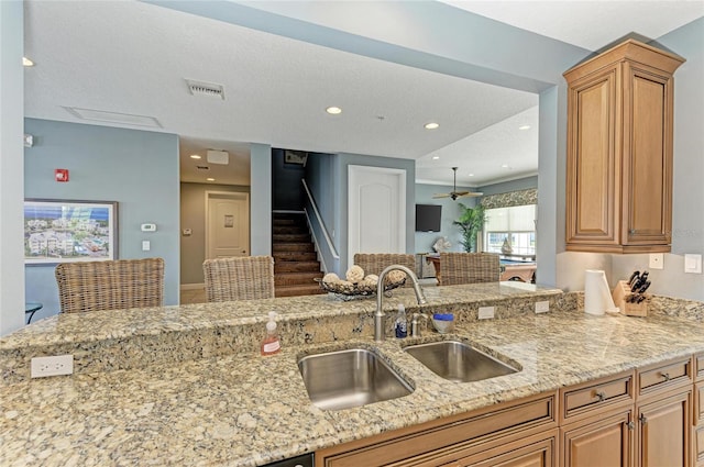 7820 34th Ave W Unit 102, Bradenton, FL 34209 - kitchen featuring light stone countertops, recessed lighting, a textured ceiling, and open floor plan