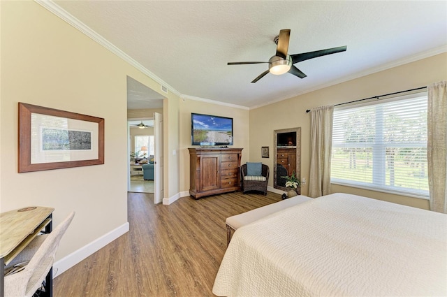 7820 34th Ave W Unit 102, Bradenton, FL 34209 - bedroom featuring wood finished floors, crown molding, and a ceiling fan