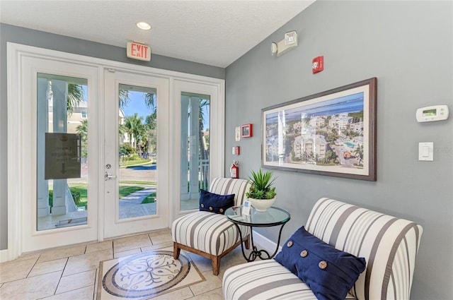 7820 34th Ave W Unit 102, Bradenton, FL 34209 - sitting room featuring plenty of natural light, tile patterned flooring, and a textured ceiling