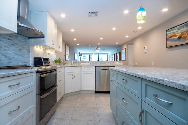 5750 Midnight Pass Rd Unit 203, Sarasota, FL 34242 - kitchen featuring appliances with stainless steel finishes, wall chimney exhaust hood, backsplash, ceiling fan, and white cabinets