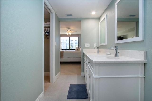 5750 Midnight Pass Rd Unit 203, Sarasota, FL 34242 - bathroom with double vanity, tile patterned floors, ceiling fan, ensuite bathroom, and a walk in closet